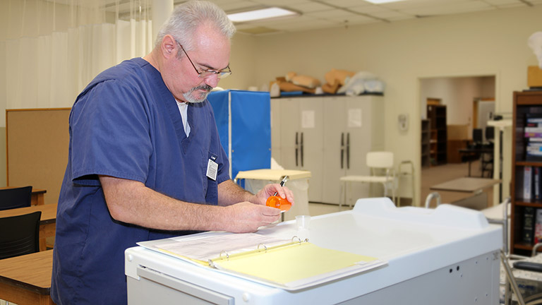medication aide dispensing medicine
